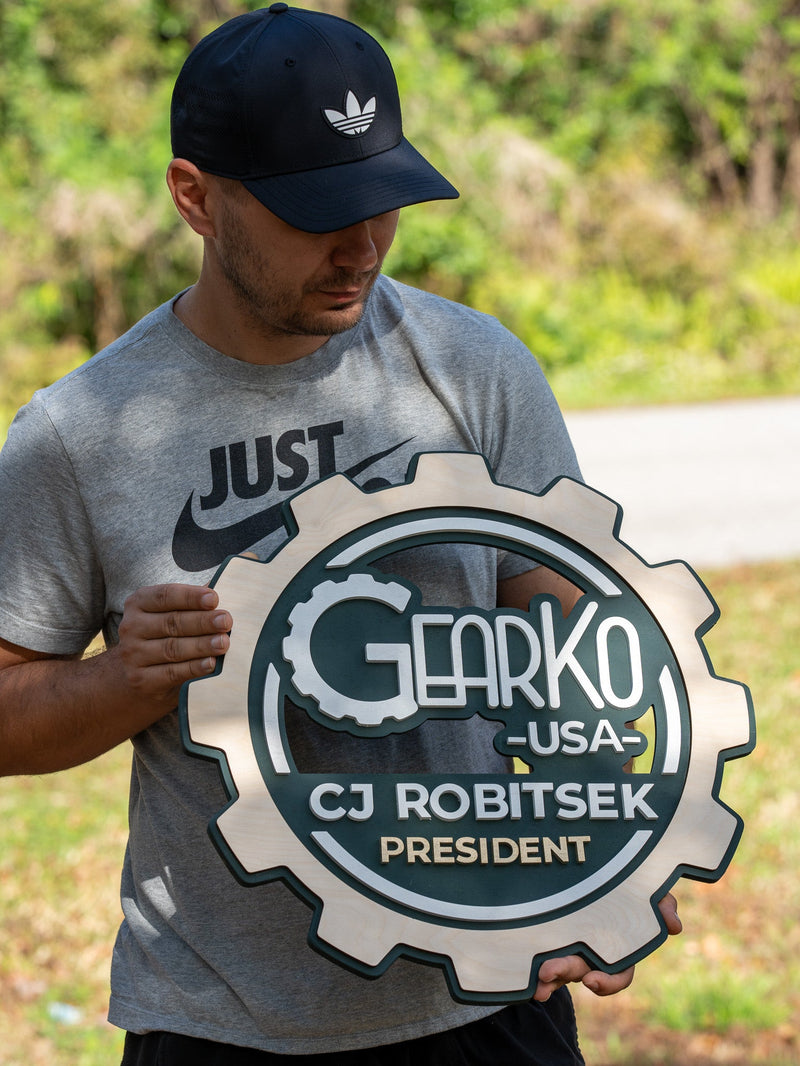 Custom 3D business logo sign with dark green backplate and gold metallic lettering, handcrafted by WoodHarmonyUS.