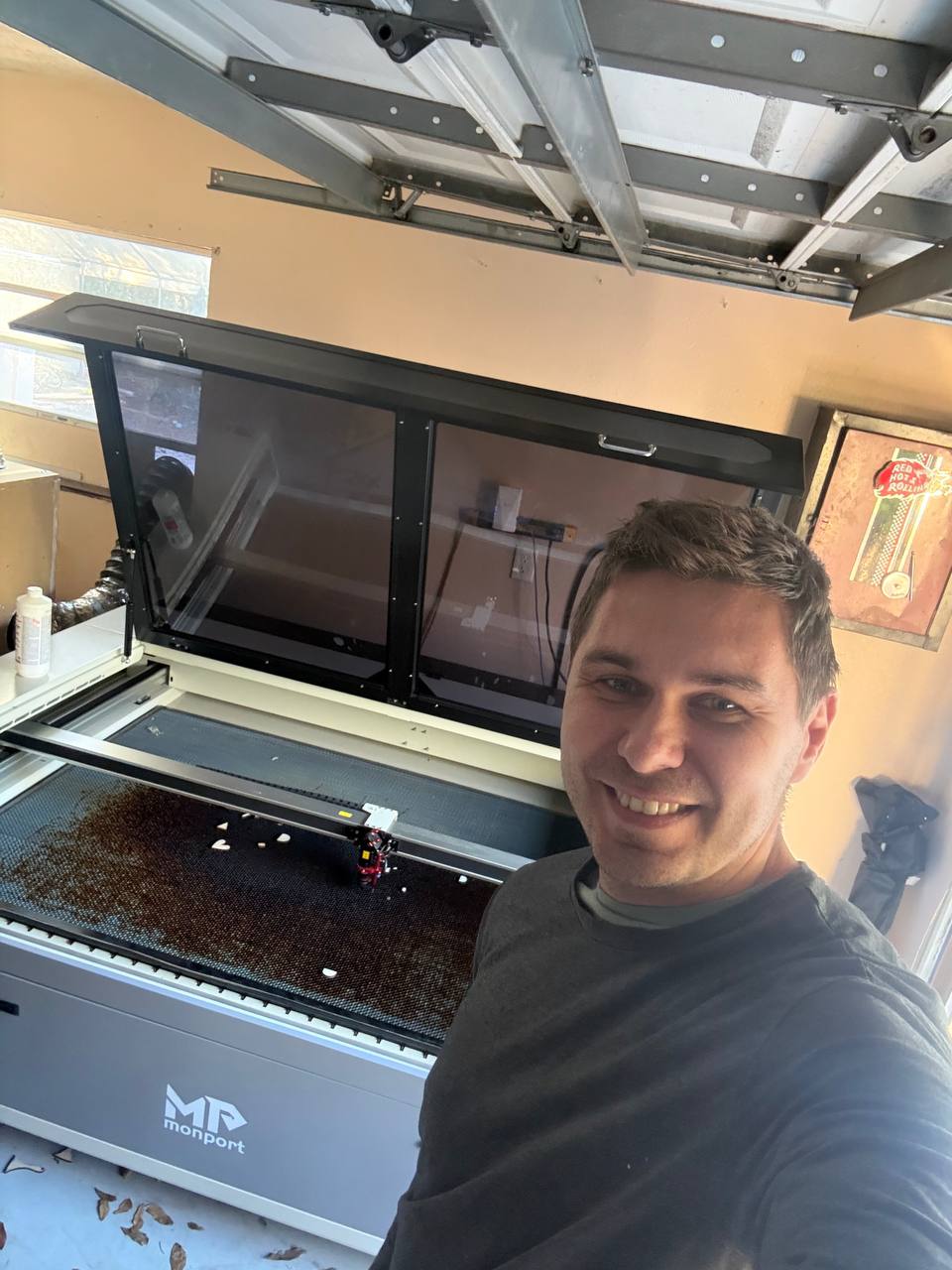 Hand-rubbing wood stain technique on Baltic Birch plywood demonstrating traditional finishing method for custom signs in Tampa workshop