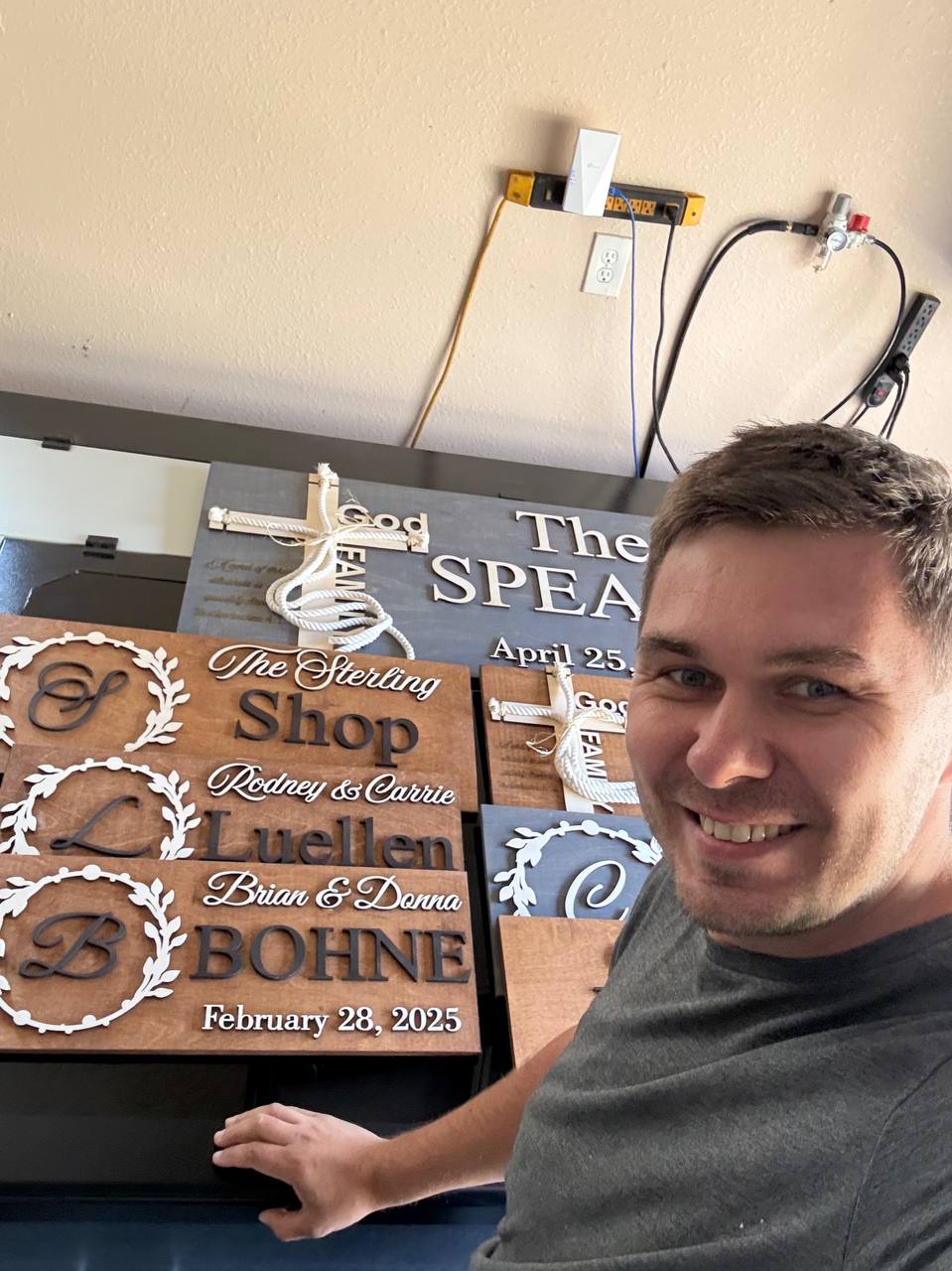 WoodHarmonyUS owner with handcrafted personalized wedding signs and custom family name signs ready for delivery in Tampa workshop