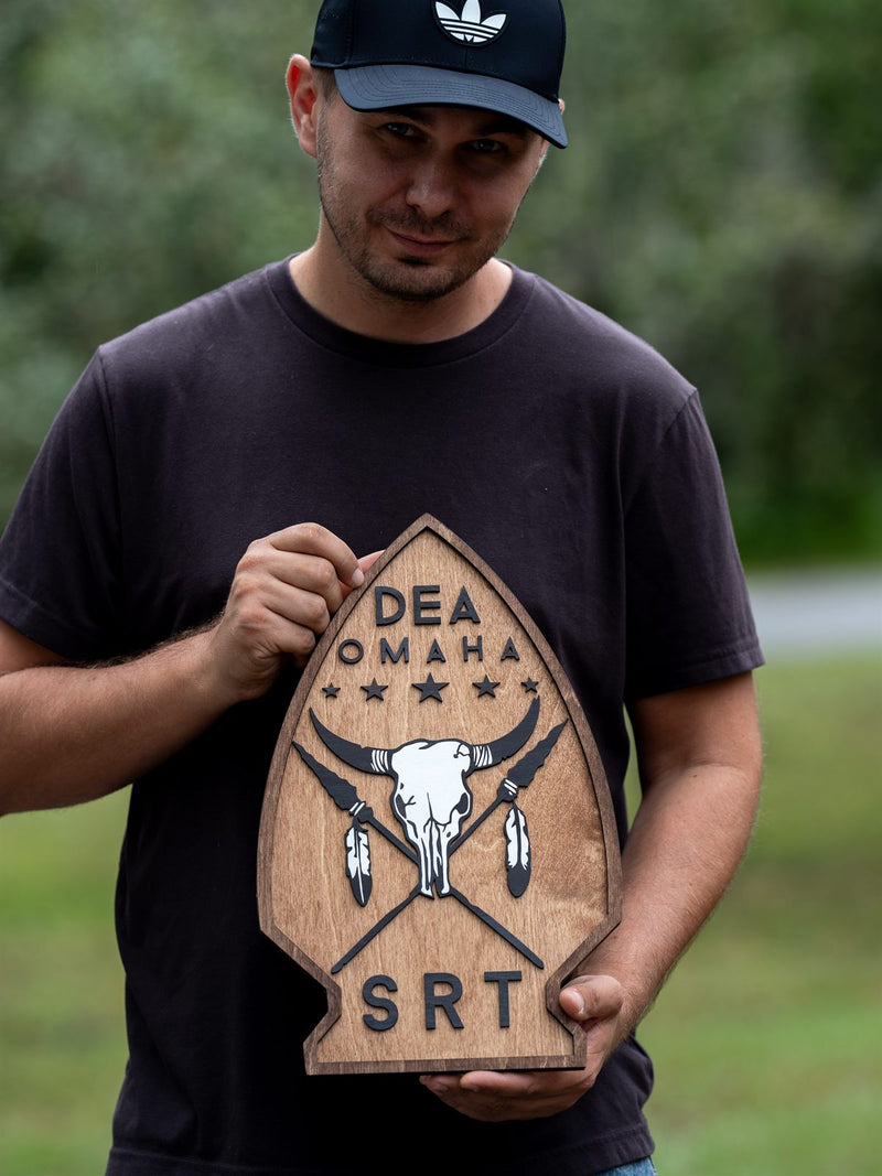 Arrowhead-shaped stained wood unit crest for DEA Omaha SRT with a white steer skull, crossed arrows and five stars