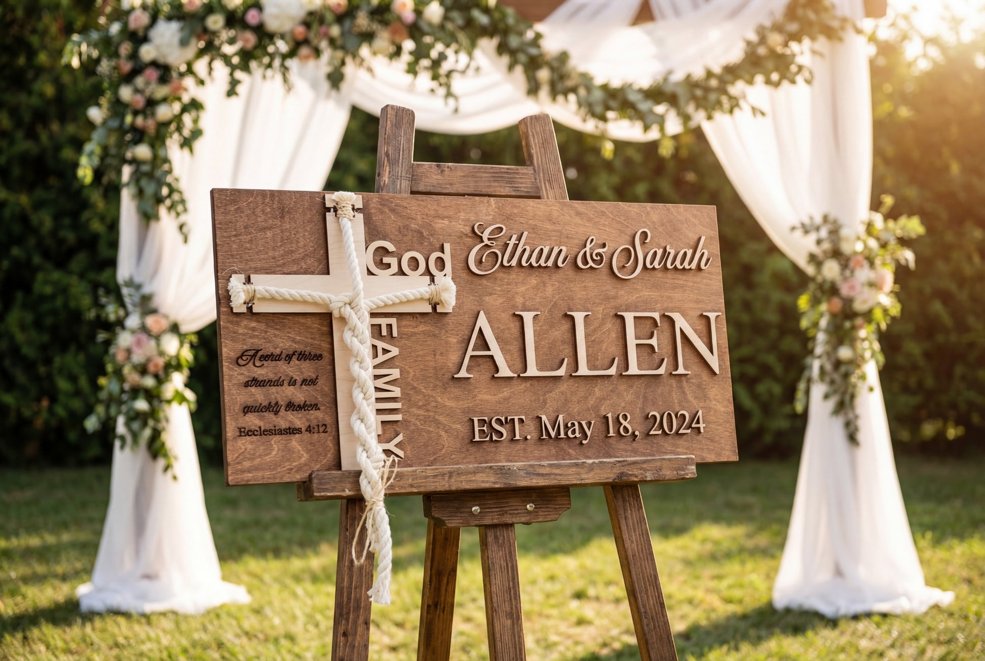 Personalized cord of three strands ceremony sign on a rustic wooden easel in a garden