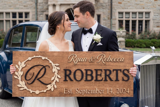 Couple holding custom family name sign Roberts wedding gift Baltic Birch