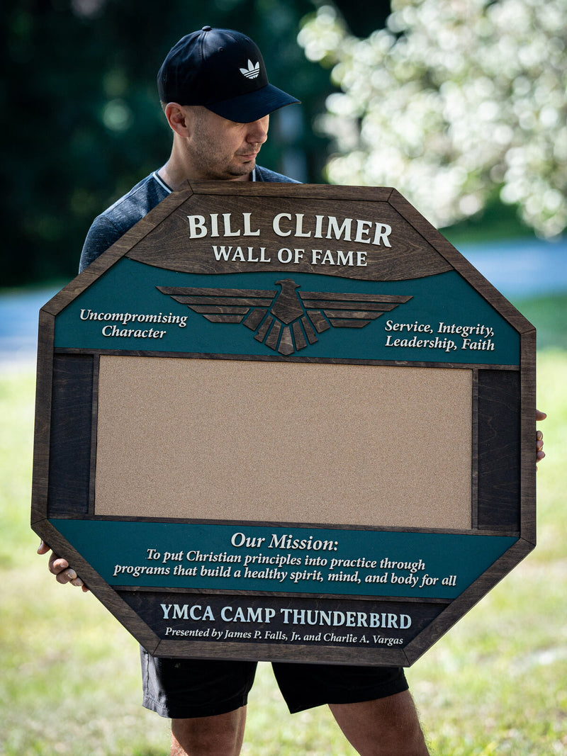 Very large octagonal dark walnut and teal recognition board with a layered thunderbird emblem and a blank cork centre panel