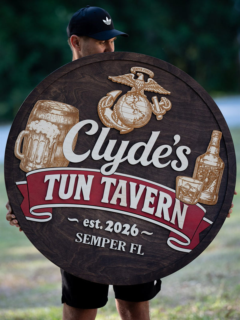 Very large round espresso-stained wood tavern sign with the Marine Corps eagle globe and anchor, an engraved beer stein, barrel and whiskey bottle