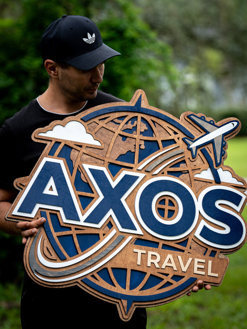 Large shaped cherry-brown wood travel agency sign with a wireframe globe, a navy and cream airplane and lettering reading AXOS Travel
