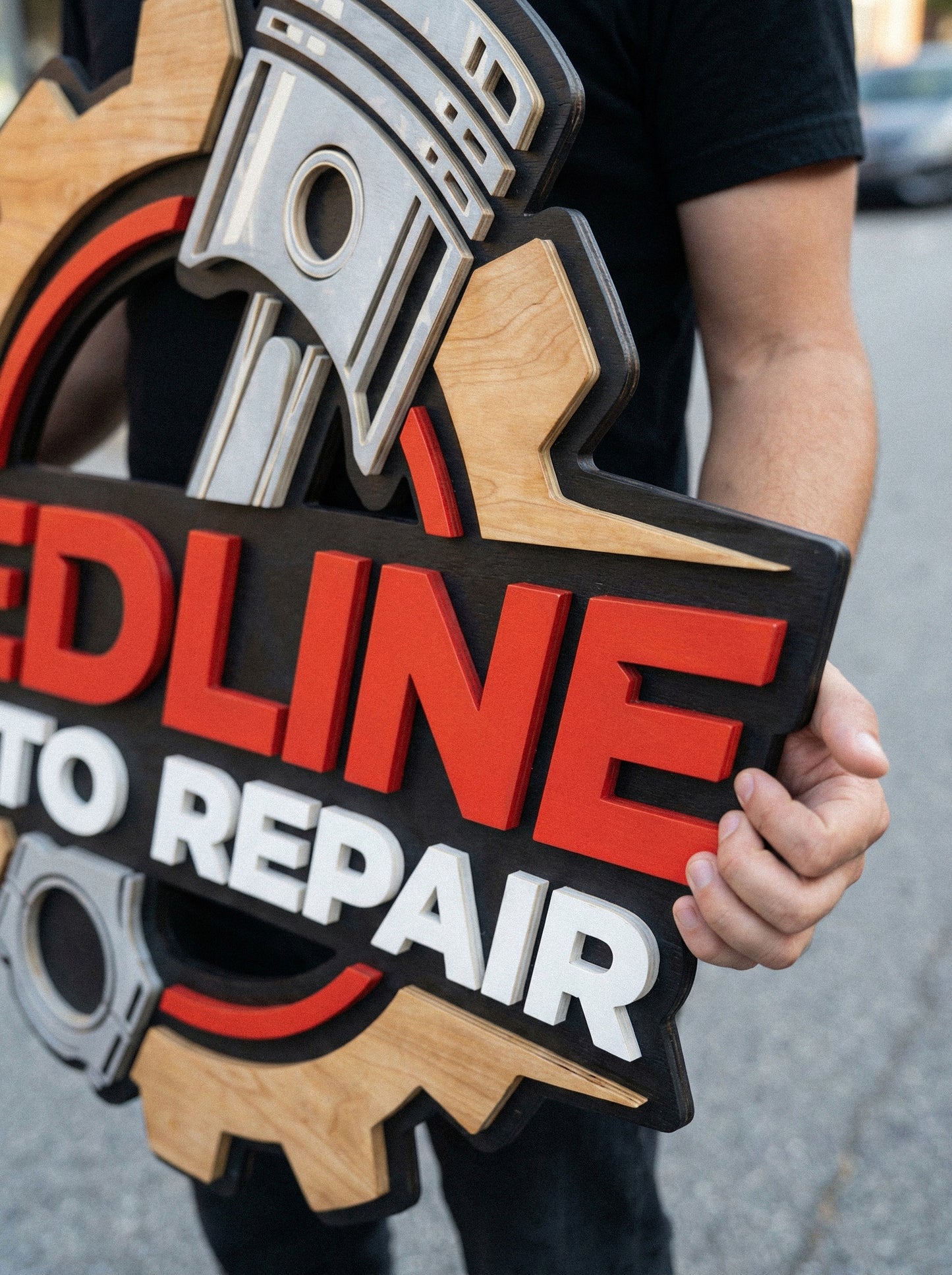 Close-up of multilayered 3D wood business sign, laser cut painted wooden logo with premium finish for reception wall.