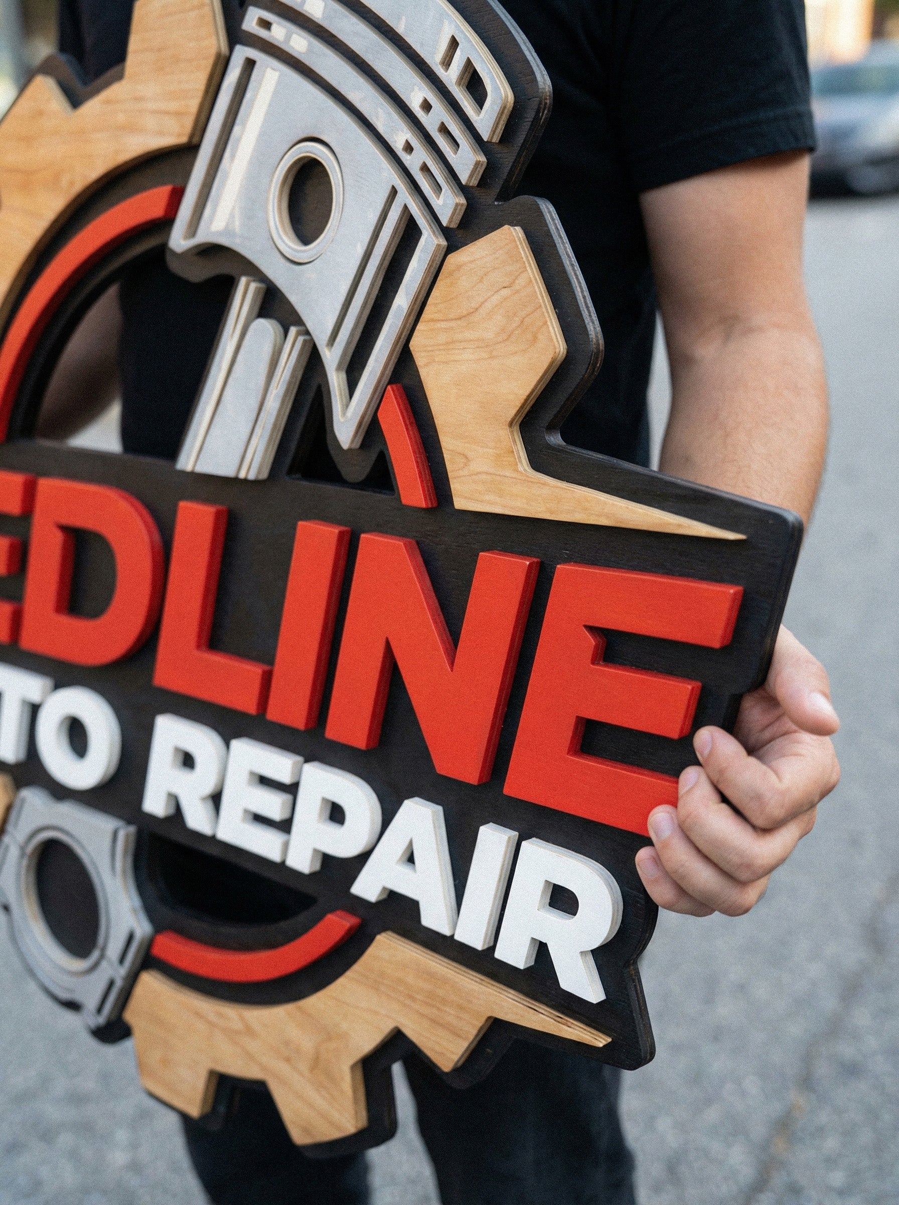 Close-up of multilayered 3D wood business sign, laser cut painted wooden logo with premium finish for reception wall.