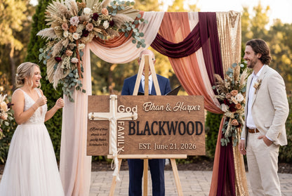 Couple beside a Blackwood family unity ceremony sign in wood with black lettering