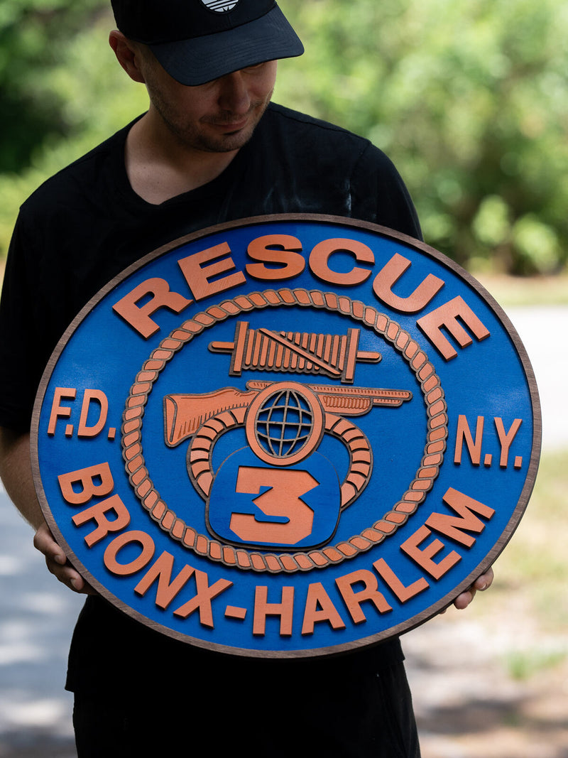 Large royal blue wood firehouse emblem with a walnut rim for FDNY Rescue Company 3 Bronx Harlem, with a rescue litter, hose nozzle and axe