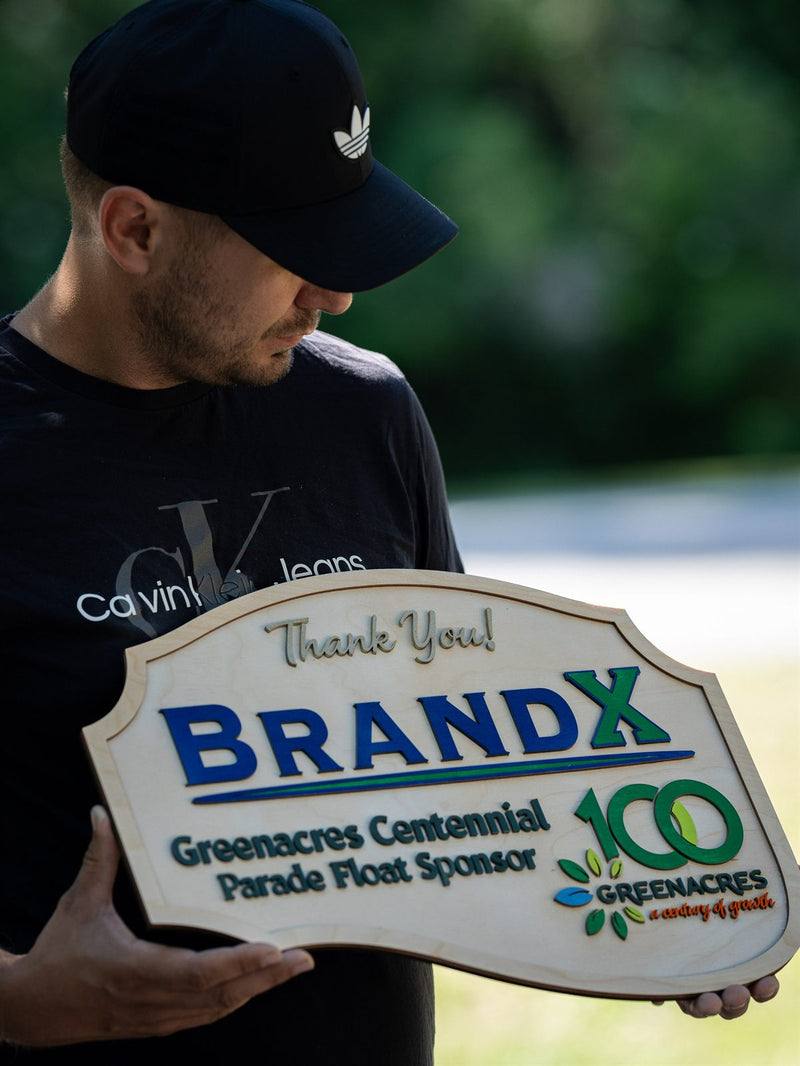 Arch-topped pale birch recognition plaque reading Thank You, BrandX, Greenacres Centennial Parade Float Sponsor